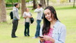 Video: A woman laughs while reading a text message before looking at the camera A woman laughs while reading a text message before looking at the camera