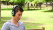 Video: Camera rises to show a man sitting with a laptop while wearing headphones Camera rises to show a man sitting with a laptop while wearing headphones