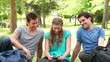Three friends posing as they take a photo of themselves before laughing