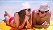 Couple lying on towels