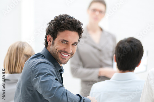Photo: Smiling man at meeting Smiling man at meeting