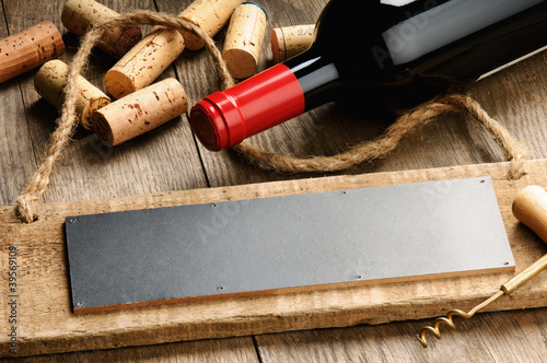 Photo: Rustic wooden board, wine and corks Rustic wooden board, wine and corks