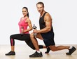 Athletic man and woman with a dumbells.