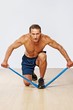 Handsome muscular man doing stretching exercise.