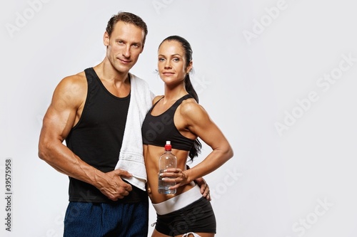 Photo: Athletic man and woman after fitness exercise Athletic man and woman after fitness exercise