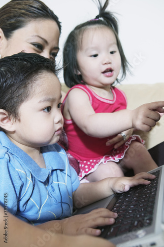 Photo: Mother with children and laptop Mother with children and laptop