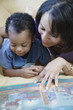 Mother and young son reading book