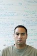 Portrait of man in front of white board