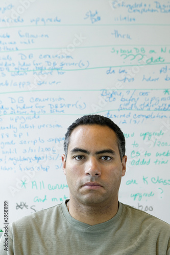 Photo: Portrait of man in front of white board Portrait of man in front of white board