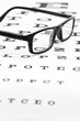 Spectacles on an eye test chart