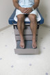Low section of male patient in gown