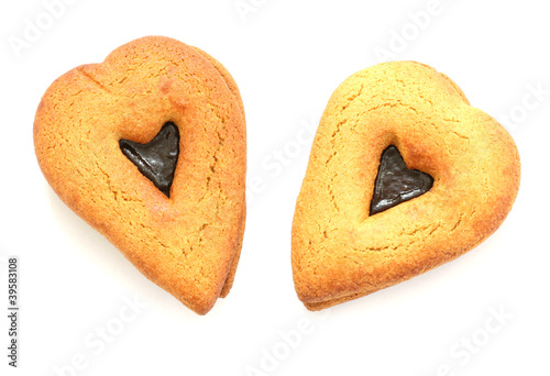 Photo: Two gingerbreads in heart shapes on white background Two gingerbreads in heart shapes on white background
