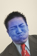 Young businessman holding breath and turning blue