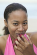 Photo: Young woman eating raspberries off of fingers Young woman eating raspberries off of fingers
