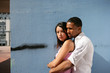 Couple hugging by wall