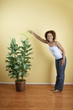 Portrait of woman watering plant