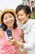 Two women taking picture with cell phone