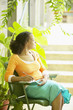 Profile of woman writing in date book outdoors