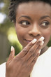 Woman with hand over mouth