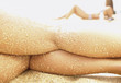 Close up of woman's legs covered with sand Close up of woman's legs covered with sand