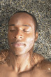 Close up of man floating in water with eyes closed
