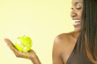 Woman holding apple and tape measure