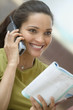 Woman reading magazine and talking on telephone