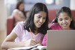 Two sisters doing homework together