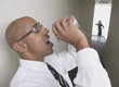 Profile of businessman talking through tin can to businesswoman