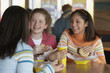 Teenage girls eating at restaurant
