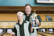 Couple with trophy at bowling alley