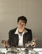 Businessman puzzling over a nest of wires