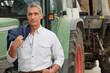 farmer posing in front of his tractor