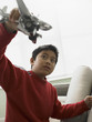 Young boy playing with a model plane