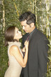 Couple hugging among tall plants