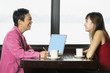 Two businesswomen sitting together at table