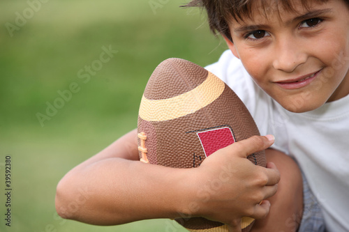 Photo: Young boy playing rugby Young boy playing rugby