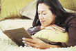 Woman reading book on bed