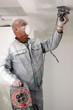 Man sanding a plasterboard ceiling