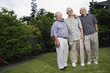 Portrait of three elderly men standing in yard