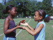 Two girls playing clapping game