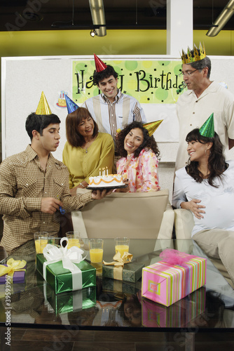 Photo: Group of coworkers at office birthday party Group of coworkers at office birthday party