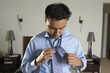 Businessman tying tie