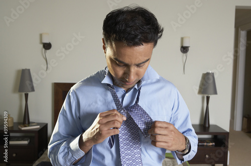Photo: Businessman tying tie Businessman tying tie