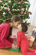 Sister and brother kissing on Christmas day