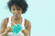 Portrait of woman with tangled yarn and knitting needles
