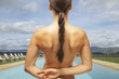 Rear view of woman's naked back at the swimming pool