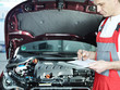 Photo: Motor mechanic in front of engine bay is checking repair details Motor mechanic in front of engine bay is checking repair details