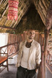 Young man smiling in a straw hut