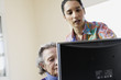 Elderly woman learning to use a computer